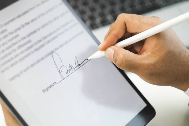 Professional signing a document electronically on a tablet using a stylus with DociShield